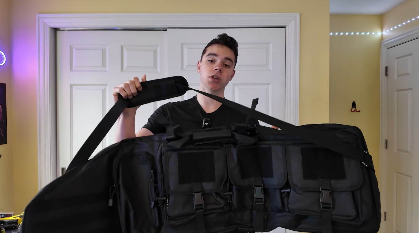 Andrew holding the entire rifle bag, showcasing its size and the shoulder strap.