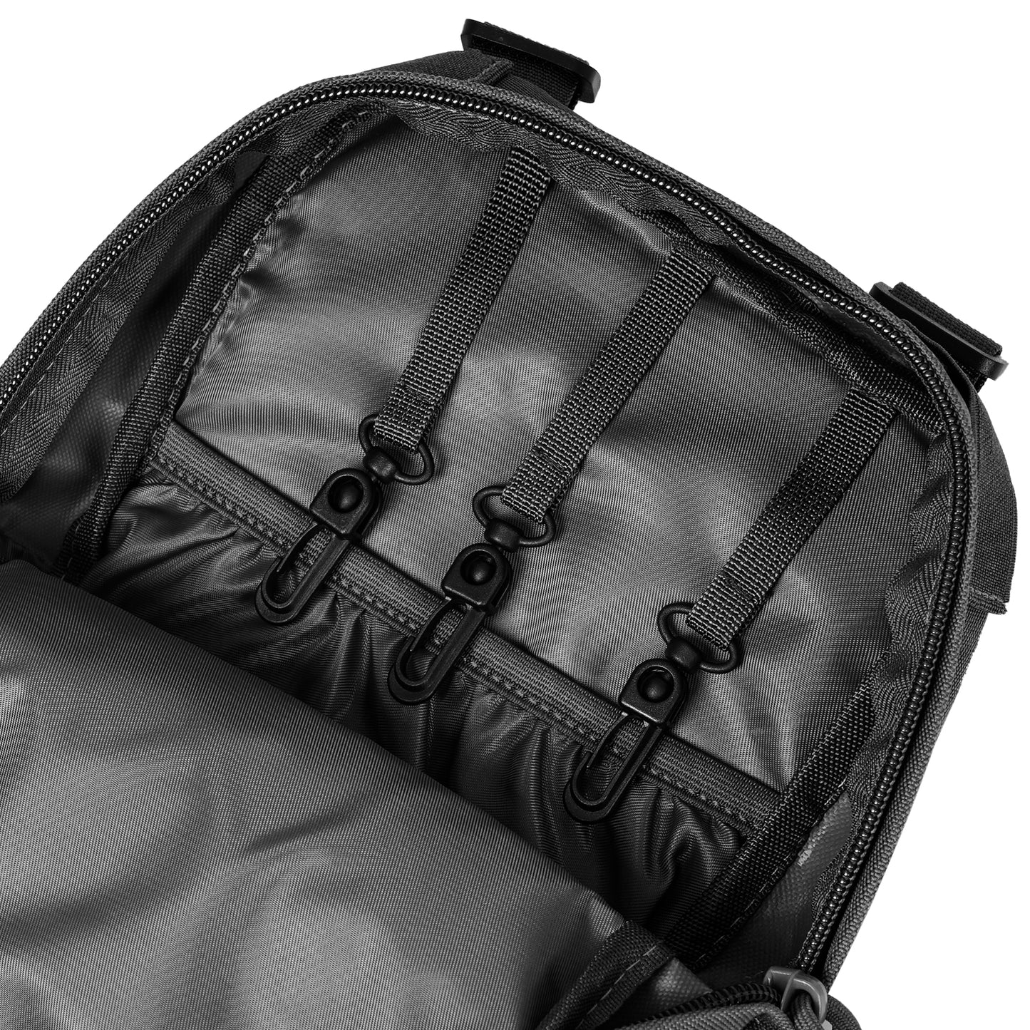 Black DULCE DOM tactical hydration backpack interior, showing durable nylon, hook closures and MOLLE webbing.