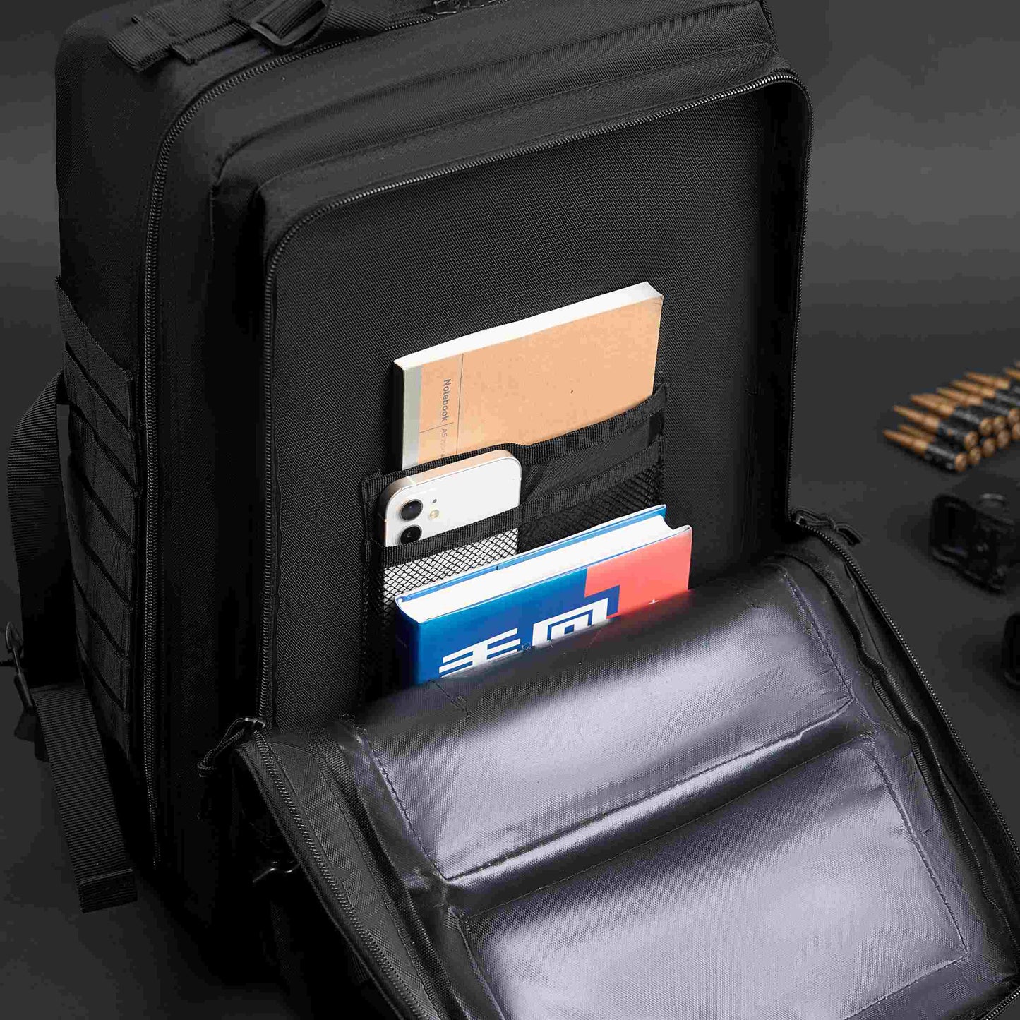 Black tactical backpack showcasing interior storage for tablet, books, and essentials. Features 900D nylon.